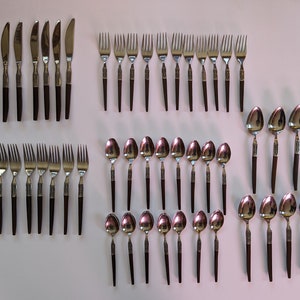 May include: A set of silverware with dark brown handles. The set includes knives, forks, and spoons.