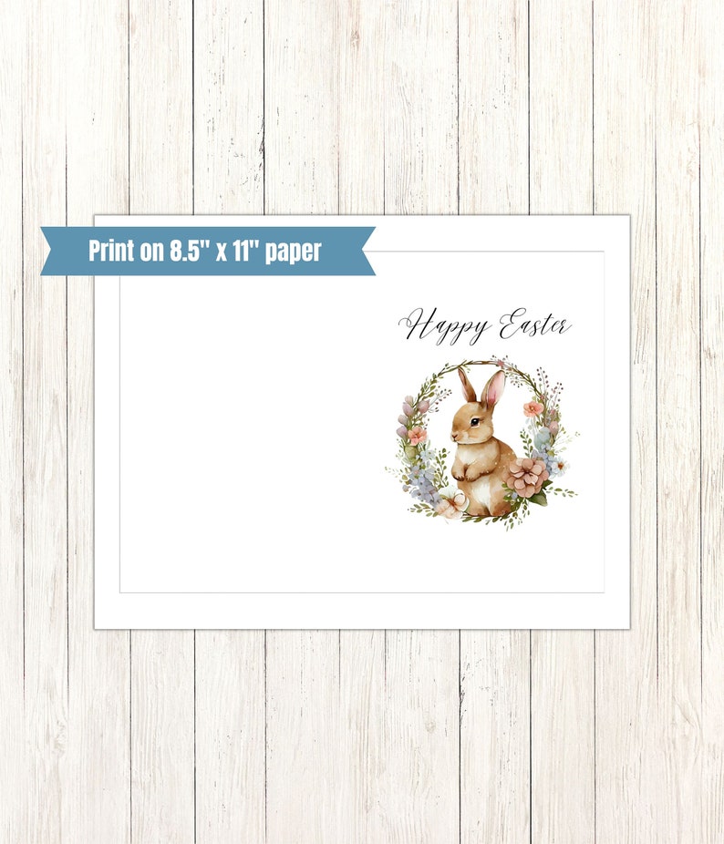 May include: A printable card with a watercolor illustration of a brown bunny rabbit sitting inside a floral wreath. The text "Happy Easter" is written in cursive above the wreath.