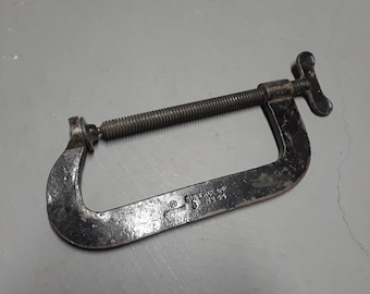 May include: A black metal C-clamp with a threaded screw and a T-shaped handle. The clamp is labelled "SUPERIOR" and "NO. 22".