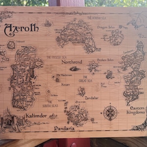 May include: A rectangular bamboo cutting board featuring a laser-engraved map of Azeroth. The map displays detailed geography, including Kalimdor, Northrend, and the Eastern Kingdoms, with labeled regions, a compass rose, and decorative border elements.