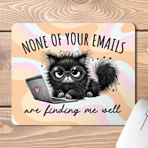 May include: A black cat wearing glasses sits at a laptop with the text "None of your emails are finding me well" on a pink and orange background.