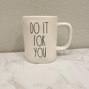 May include: White ceramic mug with black text that reads "DO IT FOR YOU".