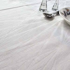 May include: A white tablecloth with a geometric pattern. The tablecloth is made of a textured fabric and has a subtle sheen.