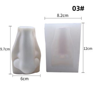 May include: A white silicone nose mold and a nose-shaped casting. The nose mold is 12 cm tall and 8.2 cm wide. The cast nose is 9.7 cm tall and 6 cm wide. The image includes the text "03#".