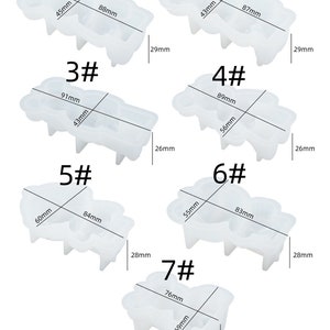 K&ouml;nnte beinhalten: Eine Sammlung von sieben transparenten Silikonformen zum Basteln. Jede Form hat eine einzigartige Form und Gr&ouml;&szlig;e, mit Messungen in Millimetern. Das Bild enth&auml;lt Abmessungen wie 88 mm, 87 mm und 91 mm. Die Formen sind von 1 bis 7 nummeriert.