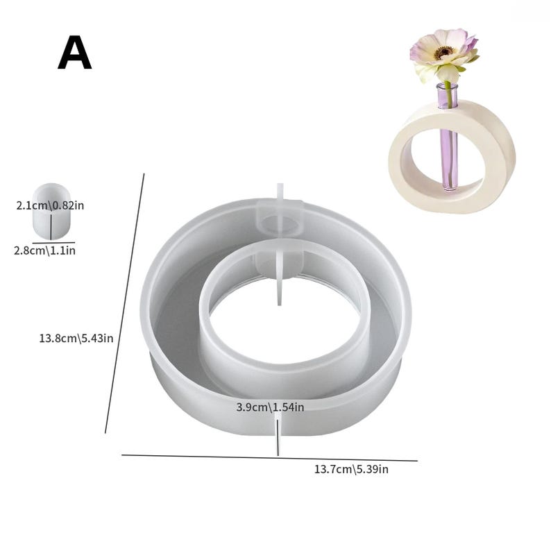 May include: A white, circular vase with a purple glass tube holding a single flower. Next to it is a gray, circular mold with a central ring. The mold measures 5.43 inches in diameter. A small, white, oval-shaped object is also shown.