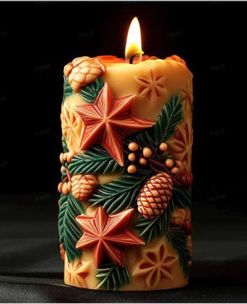 May include: A lit, cylindrical candle with a festive design. The candle features carved red stars, green leaves, and pinecones. The candle is a warm beige color, with a bright yellow flame.