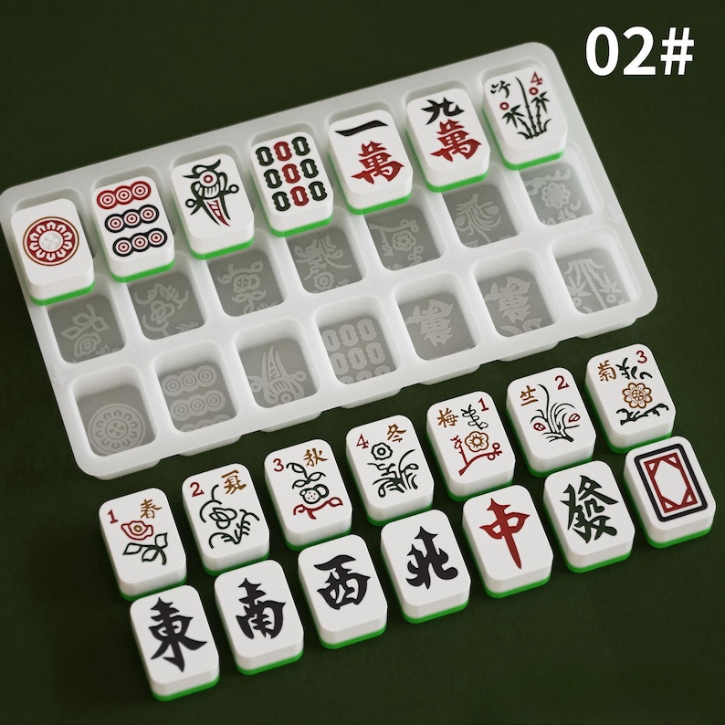May include: A set of white and green Mahjong tiles with red and black symbols and characters. The tiles are arranged in a clear plastic tray. The image also includes the text "02#".