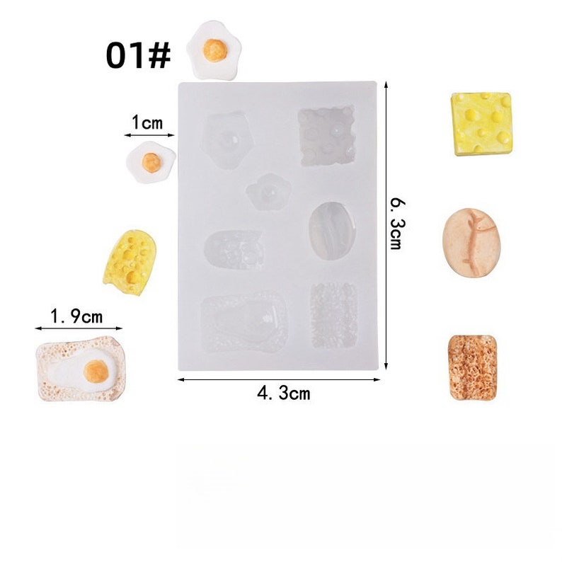 May include: A silicone mold with various food shapes, including eggs, cheese, and toast, alongside finished resin pieces. The mold measures 6.3 cm x 4.3 cm. The text "01#" is visible in the upper left corner. The finished pieces are approximately 1.9 cm x 1 cm.
