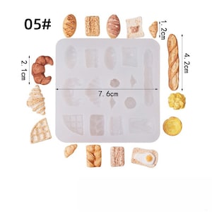 May include: A silicone mold with various miniature bread shapes, including croissants, a baguette (4.2 cm), and a waffle. The mold itself measures 7.6 cm across. The image also shows several finished bread miniatures, with a croissant measuring 2.1 cm.