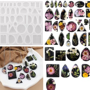 May include: A clear silicone mould with diverse shapes for resin art, and finished resin pendants. The pendants feature dried flowers in black resin, showcasing a variety of floral designs and colours. Some pendants are on gold chains.