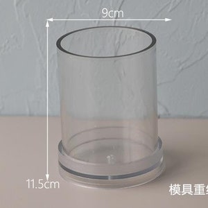 May include: A clear, cylindrical container with a 3.5-inch diameter and a height of 4.5 inches. The base has a frosted band. The text in the image says the mold weighs approximately 5.1 ounces.