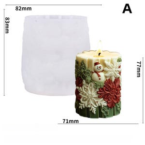 May include: A lit, festive candle with a snowman and snowflake design, measuring 77mm high and 71mm wide. The candle is surrounded by red, green, and white decorative elements. A clear, textured mold, 83mm high and 82mm wide, is also shown.