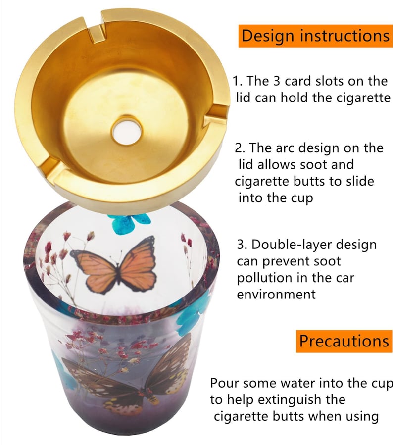 Puede incluir: Un cenicero de dos piezas. La parte superior es de metal dorado con tres ranuras para cigarrillos. La parte inferior es una taza de vidrio transparente con dise&ntilde;os de mariposas y flores. Instrucciones de dise&ntilde;o visibles.