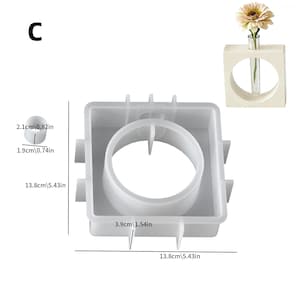 May include: A clear, square resin mold with a large central opening, ideal for crafting. Dimensions are 5.43 inches by 5.43 inches. A small, round resin piece is also shown, measuring 0.82 inches in diameter. A small, wooden vase with a single flower is also shown.