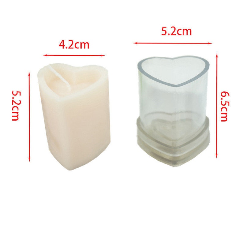 May include: A heart-shaped candle and a clear plastic mold. The candle is 5.2 cm tall and 4.2 cm wide. The mold is 6.5 cm tall and 5.2 cm wide. The candle is off-white, and the mold is transparent.