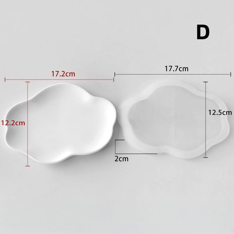 May include: Two cloud-shaped trays, one solid white and the other transparent. The white tray measures 17.2cm x 12.2cm. The transparent tray measures 17.7cm x 12.5cm. Both trays are 2cm thick. The letter "D" is in the upper right corner.