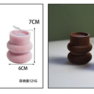 May include: The image showcases a candle-making mold and finished candles. The mold is white and cylindrical, measuring 7.2 cm in diameter and height. The finished candles are stacked, with a ribbed design, in pink and brown. The pink candle is 6 cm wide and 7 cm tall.