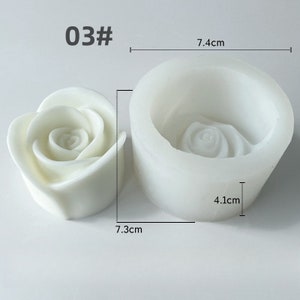 May include: A white rose-shaped candle and a white silicone mould. The mould is 7.4 cm wide and 4.1 cm tall. The candle is 7.3 cm wide. The text "03#" is in the upper left corner.