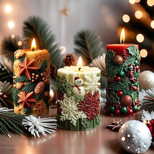 May include: Three lit, decorative Christmas candles. The candles are cylindrical and feature detailed relief designs of stars, pinecones, snowflakes, and a snowman. Colors include red, green, white, and gold. The candles are on a wooden surface with blurred holiday decorations in the background.