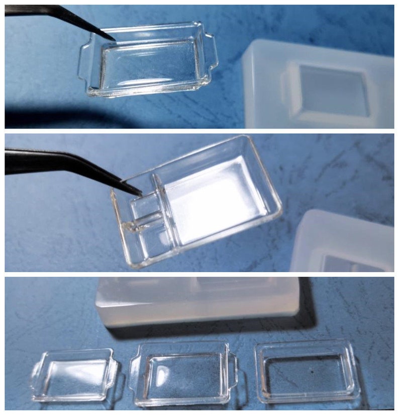 May include: Clear rectangular resin moulds with handles, shown in multiple views. One mould has a divider. The moulds are being held with tweezers. The background is a light blue surface.