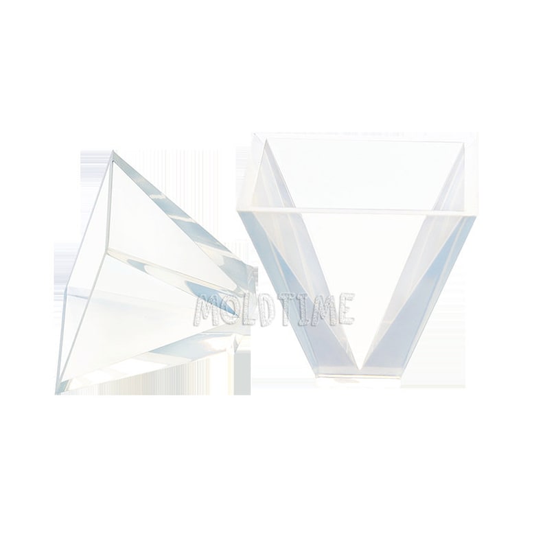 May include: Two clear, geometric, prism-shaped moulds. The moulds are transparent and have a V-shaped design. The text "MOLD TIME" is visible on the moulds.