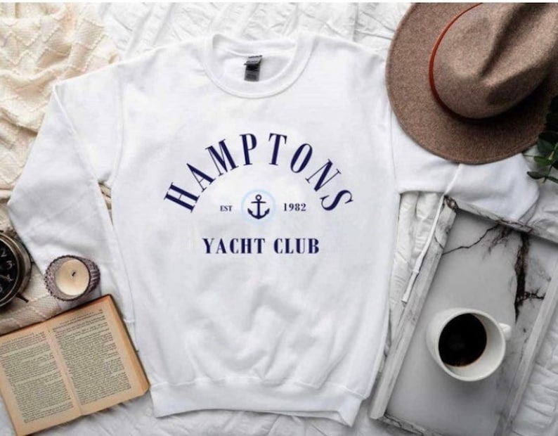 May include: White sweatshirt with a navy blue graphic that says "HAMPTONS EST 1982 YACHT CLUB" with an anchor symbol.