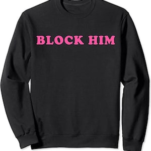 May include: Black sweatshirt with the phrase "BLOCK HIM" in pink letters.
