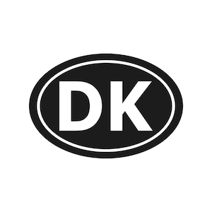 May include: A black and white oval sticker with the letters "DK" in bold white font. The letters are centered within the black oval, which is outlined with a thin white border.