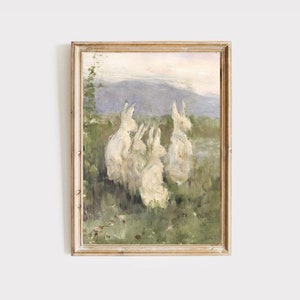 Puede incluir: Una pintura enmarcada de un grupo de conejos blancos en un campo. Los conejos est&aacute;n sentados en c&iacute;rculo, mir&aacute;ndose. El fondo es un paisaje borroso con una monta&ntilde;a en la distancia.
