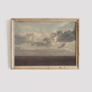 May include: A framed painting depicting a seascape with a cloudy sky and a dark blue ocean. The painting is in a light wood frame.