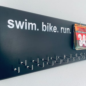 Triathlon Medal Holder / Hanger, gray or black with chrome &quot;swim. bike. run.&quot; vinyl, 21 hooks and BIB holder
