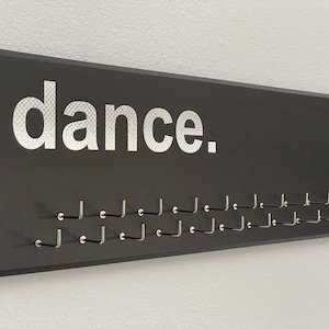 Dancing Medal Holder, black or gray with carbon silver &quot;dance.&quot; vinyl, medal hanger with 11 or 21 hooks.