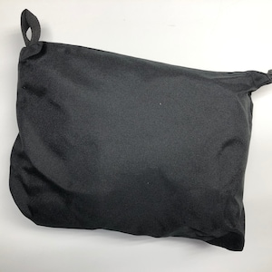 May include: A black drawstring bag with a zipper closure.