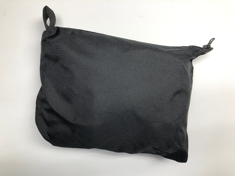 May include: A black drawstring bag with a zipper closure.