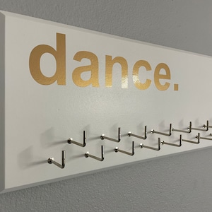 Dancing / Dance Medal Holder, various colors (white, gray or black) with gold &quot;dance.&quot; vinyl and 21 hooks.