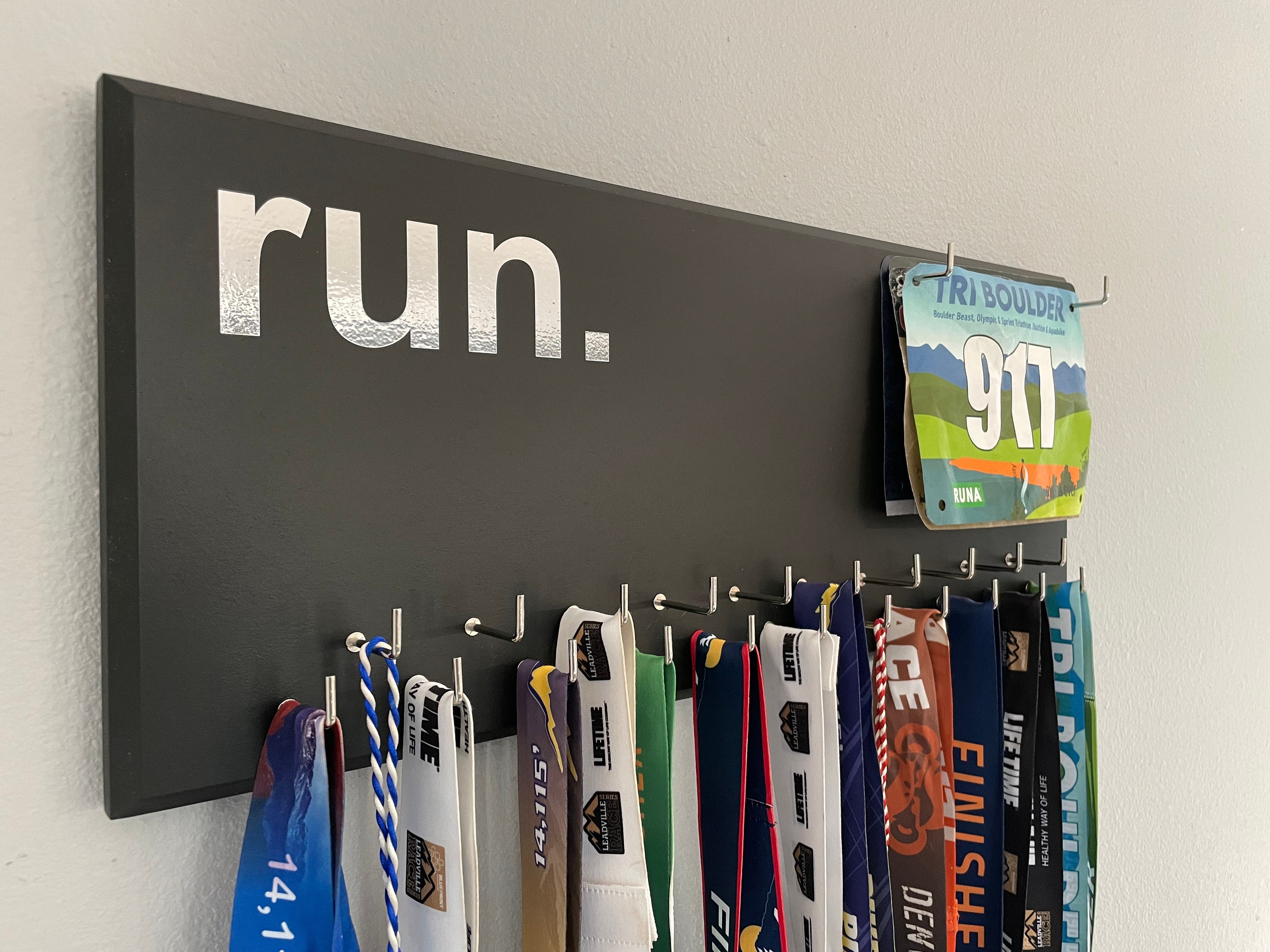 Running Medal Holder, gray or black with chrome "run." vinyl, 21 hooks and BIB holder