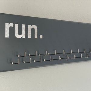Running Medal Holder, gray with carbon silver &quot;run.&quot; vinyl, medal hanger with 11 or 21 hooks.