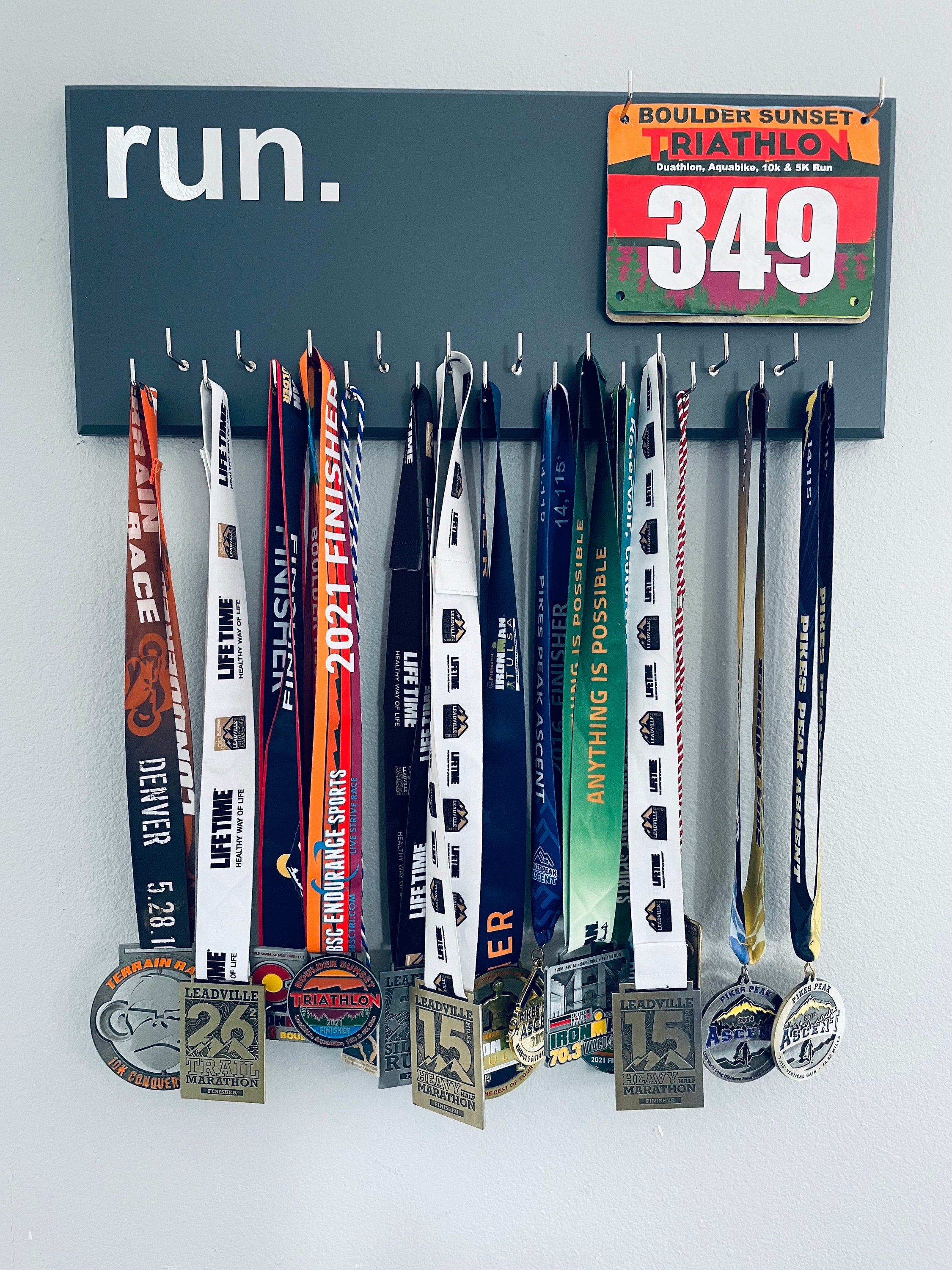 Running Medal Holder, gray or black with chrome "run." vinyl, 21 hooks and BIB holder