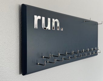 Running Medal Holder with 3D lettering, gray or black with 3D acrylic "run." letters, 21 hooks and BIB holder