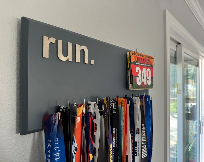 Running Medal Holder with 3D lettering, gray or black with 3D brushed aluminum "run." letters, 21 hooks and BIB holder