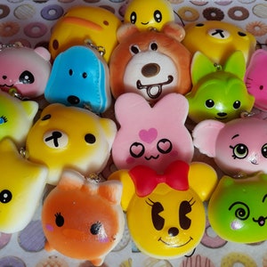 May include: A collection of colorful squishy toys with various animal and cartoon faces. The toys are made of soft, squishy material and have a variety of expressions.