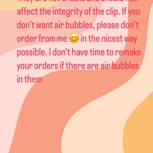 May include: Text on a pink, orange, and yellow background that reads: "Air bubbles are common in resin. They are not cracks and should not affect the integrity of the clip. If you don't want air bubbles, please don't order from me in the nicest way possible. I don't have time to remake your orders if there are air bubbles in them."