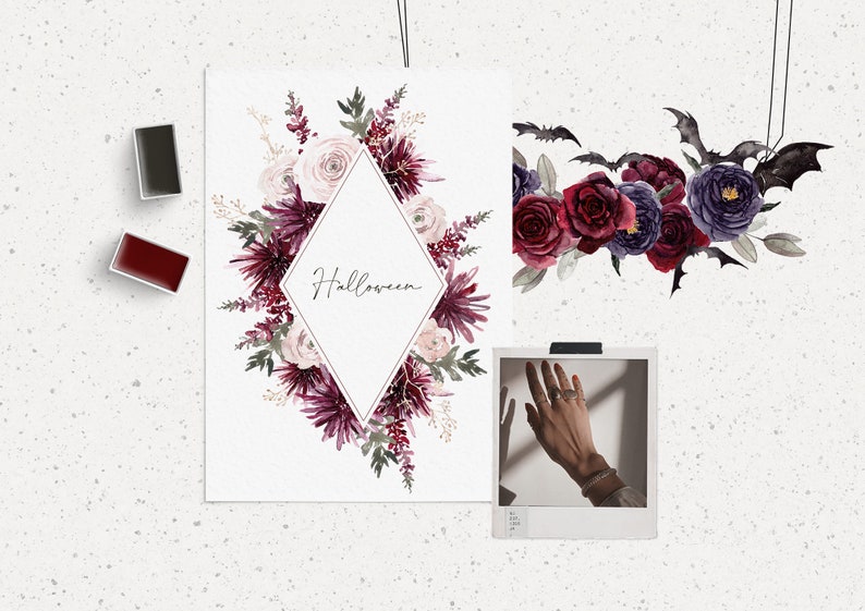 May include: A watercolor illustration of a floral wreath with burgundy and pink flowers, leaves, and berries. The wreath is in a diamond shape with the word "Halloween" written in the center. There are also bats and flowers in the background.