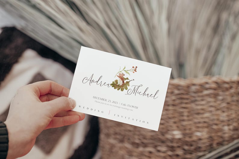 May include: A white wedding invitation card with a watercolor illustration of a squirrel on a branch with red berries. The text on the card reads "Andrea & Michael" and "December 22, 2023 |  Cole, FL |  Wedding Invitation".