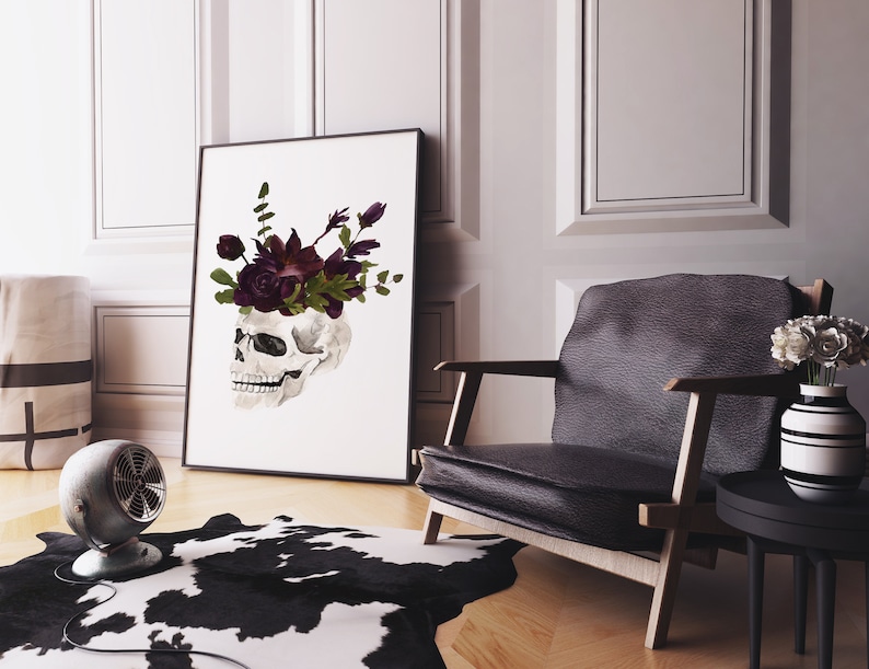 May include: A black and white skull with a crown of dark purple flowers on a white background.