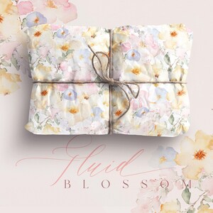 May include: A gift wrapped in white paper with a watercolor floral pattern. The paper is tied with twine and features a delicate floral design in shades of pink, yellow, and blue. The text "Fluid Blossom" is written in cursive on the bottom of the image.