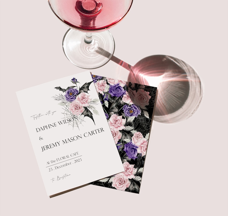 May include: A wedding invitation with a gothic floral design. The invitation features a black bat, spiderwebs, and purple and pink roses. The text reads "Together with you, Daphne Wilson & Jeremy Mason Carter, At the Floral Cafe, 23. December 2023, to Brighton."