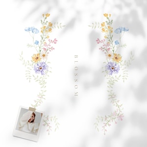 May include: Watercolor floral design featuring delicate blooms in shades of yellow, blue, pink, and purple, with green foliage. The word "BLOSSOM" is vertically printed. A polaroid photo is attached to the design.