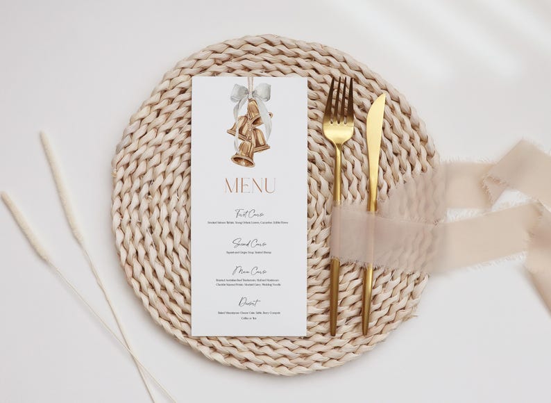 May include: A white rectangular menu card featuring a watercolor illustration of three gold bells tied with a grey ribbon at the top. The text reads MENU followed by First Course, Second Course, Main Course, and Dessert with listed items below.